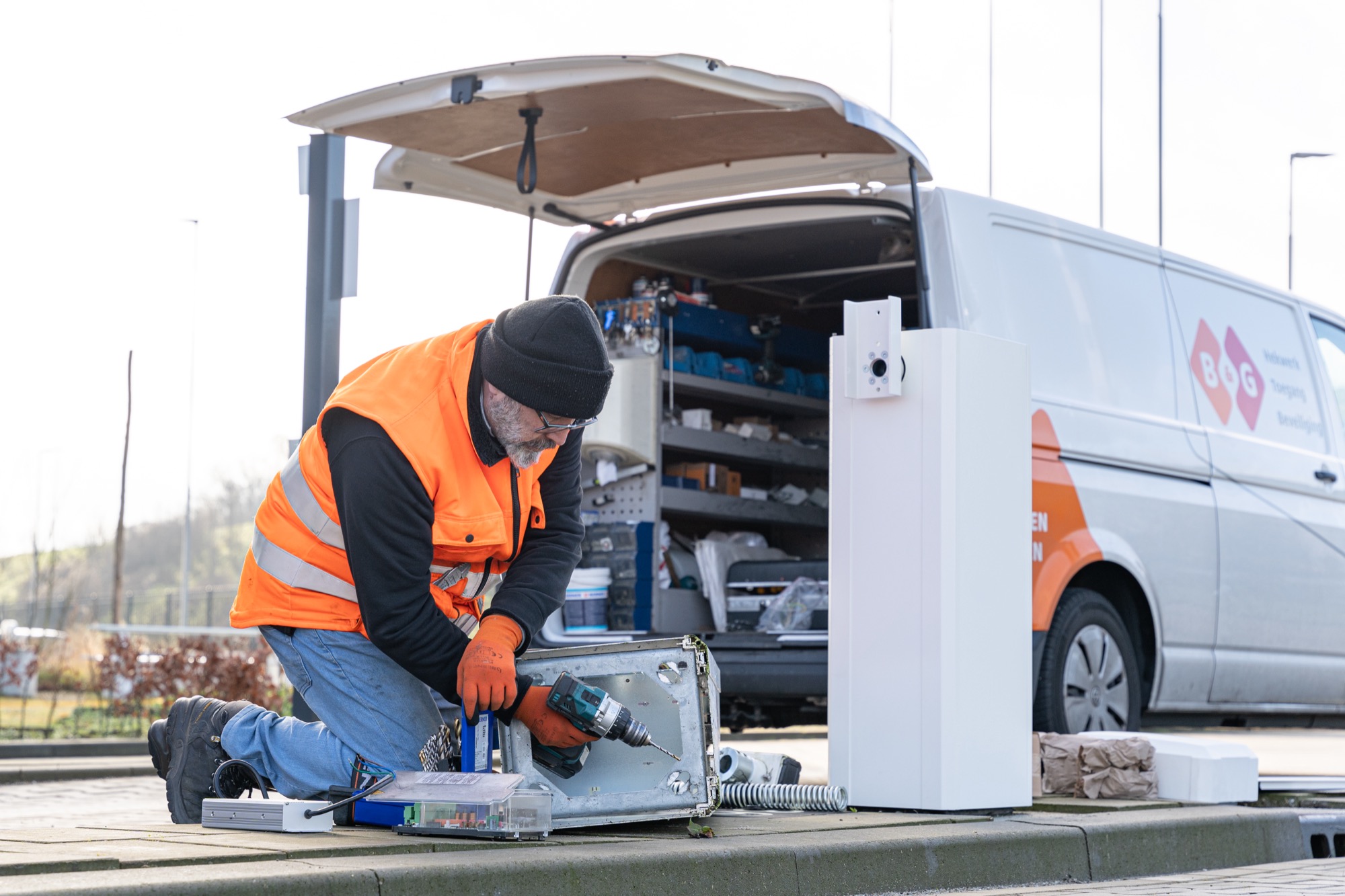 Service technician working on the control cabinet of an access installation